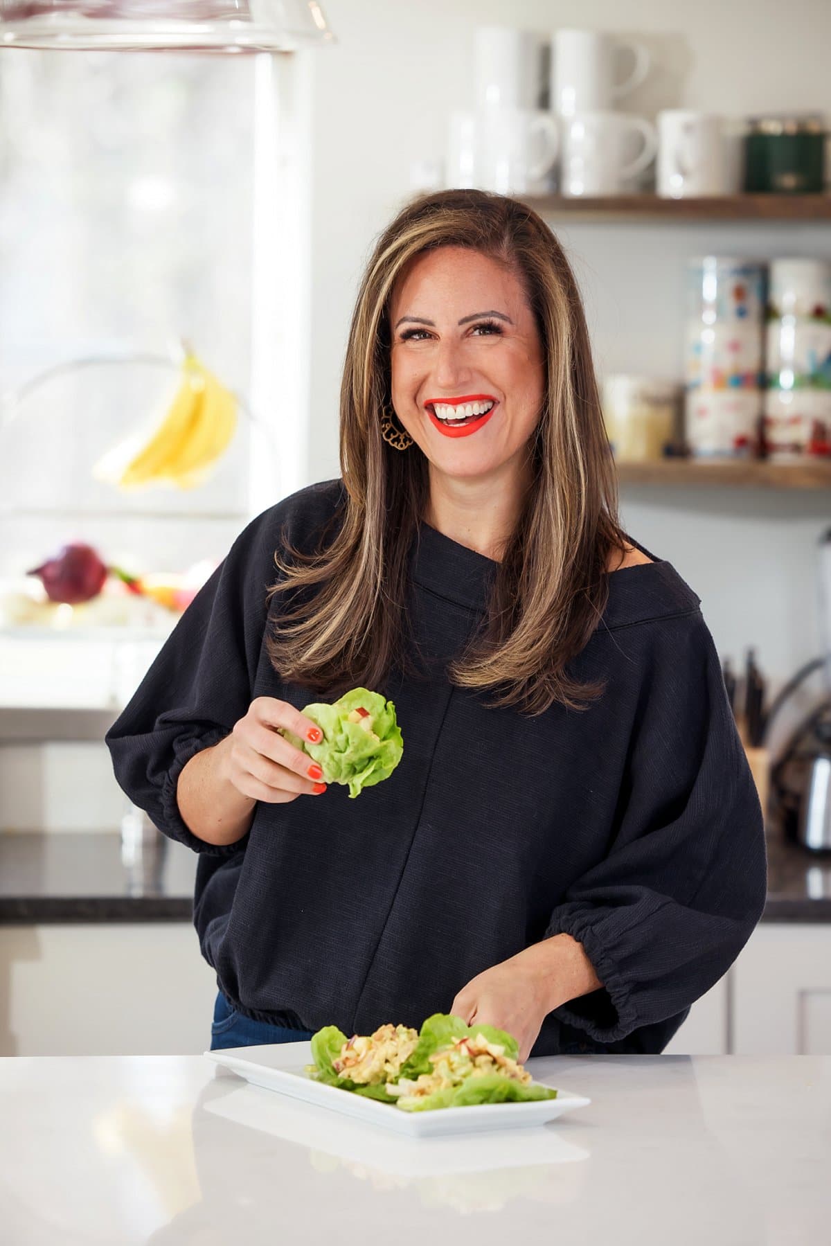 posing for a camera eating curried chicken salad with apples