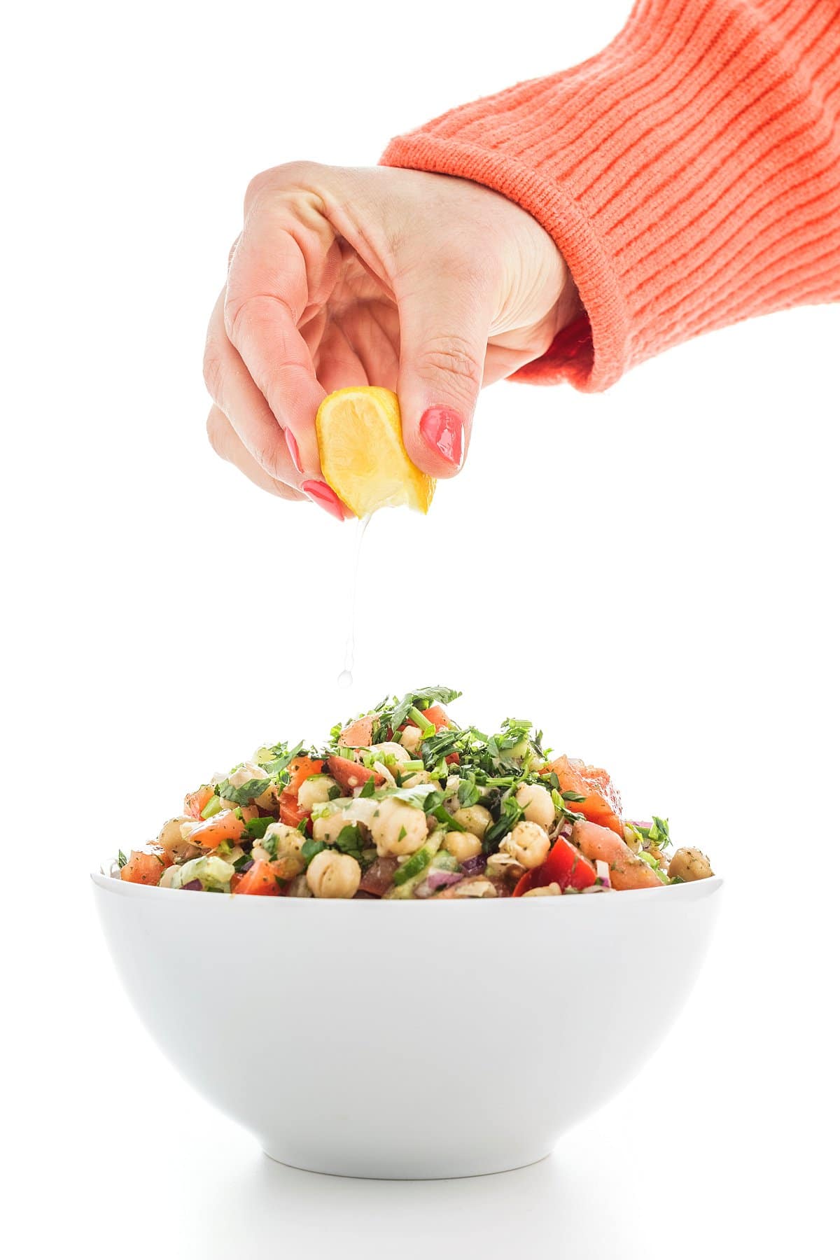 Liz squeezing lemon on chickpea salad