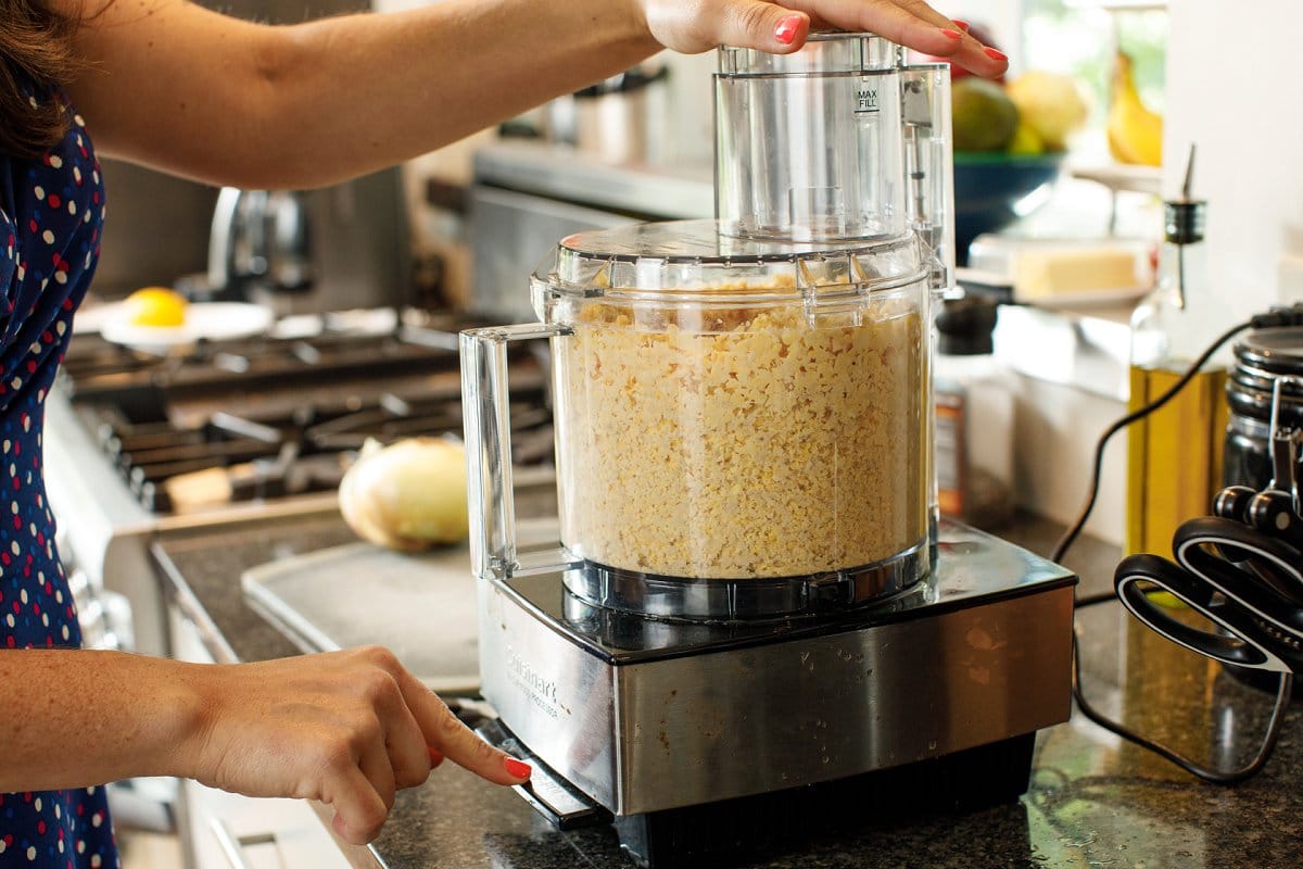 Pulsing soaked chickpeas in a food processor.