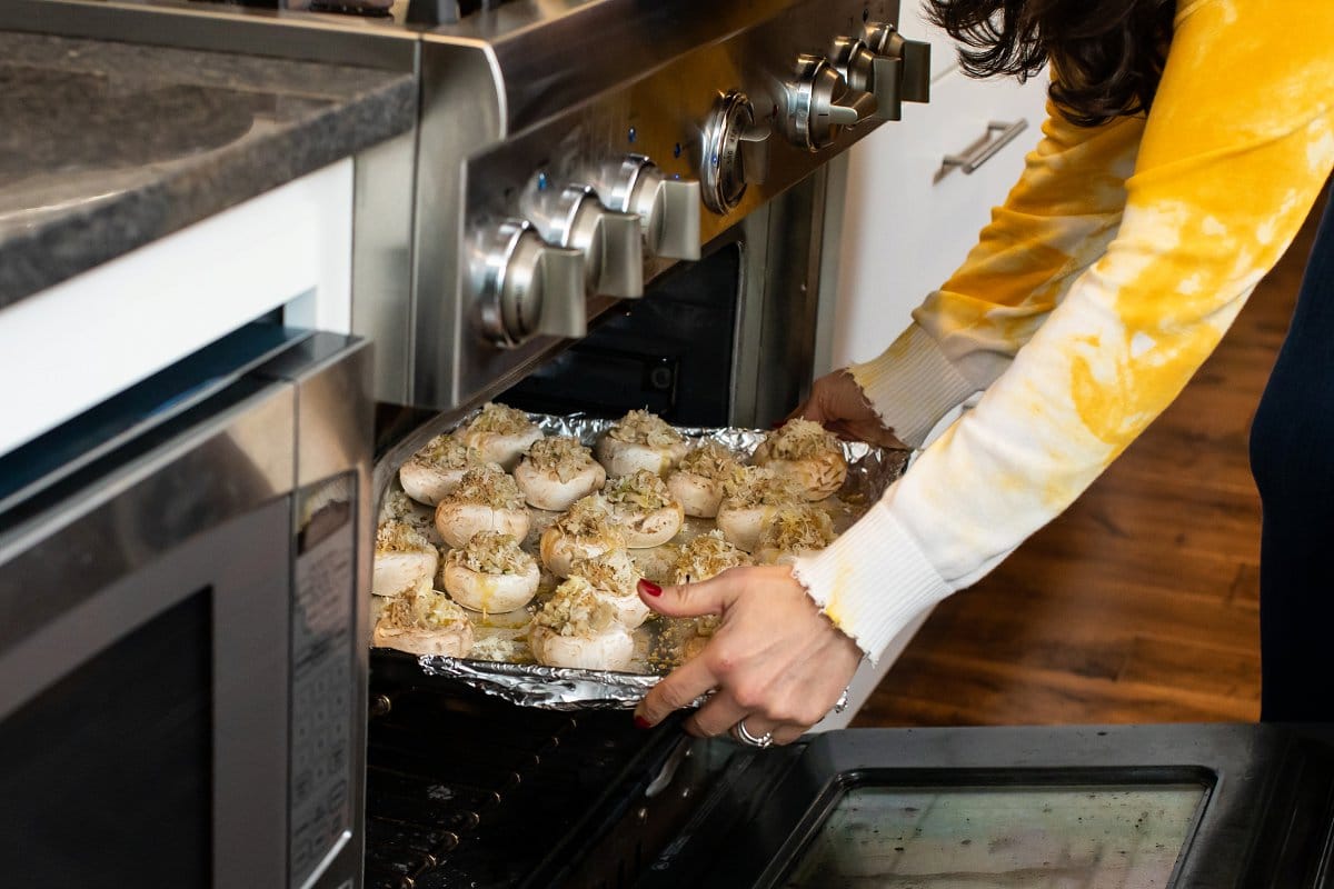 Stuffed mushrooms being placed in oven
