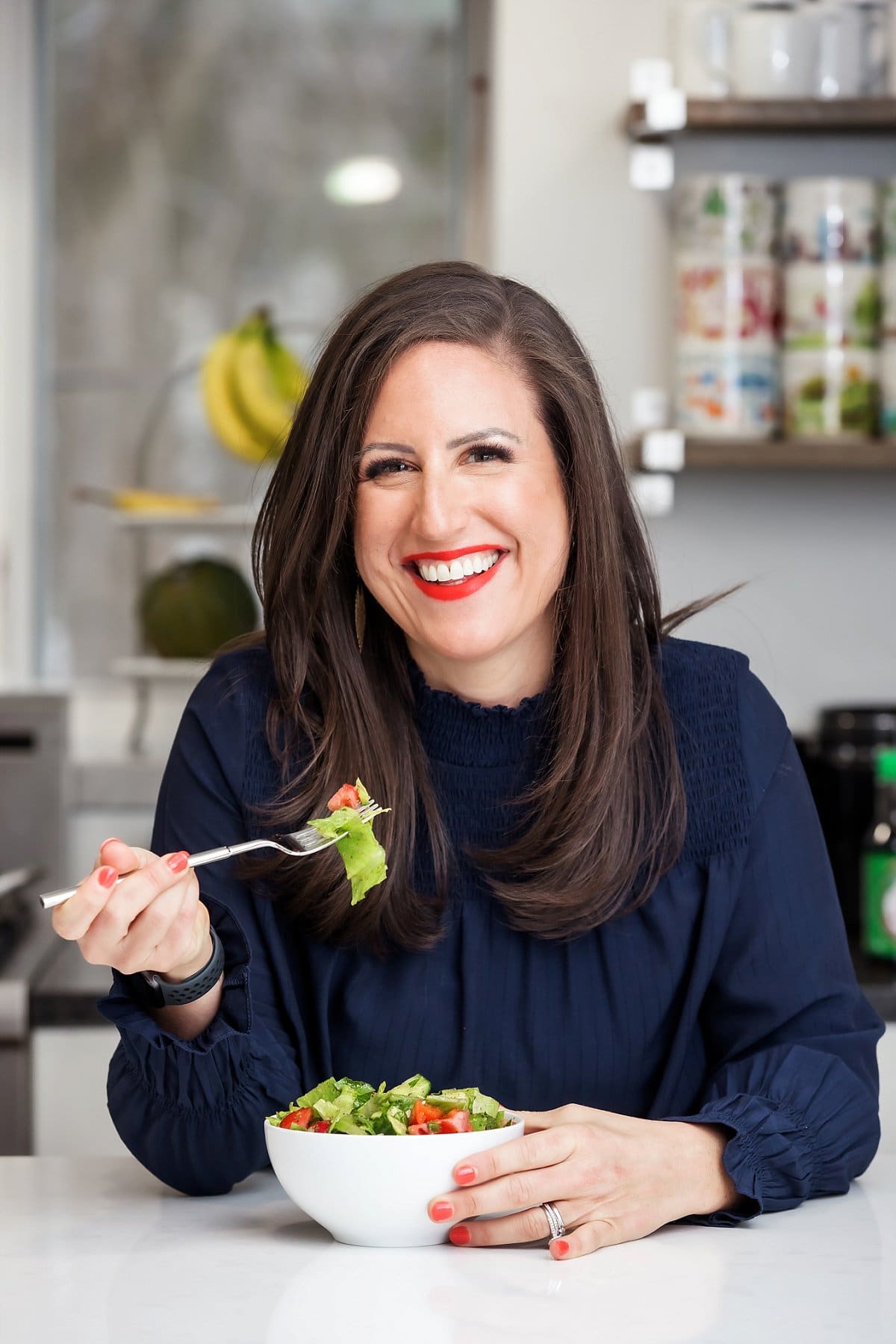 salad on a fork with person smiling