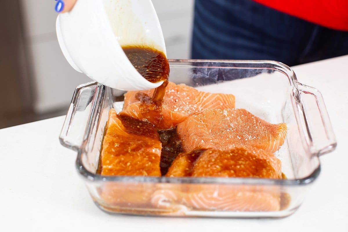 Liz pouring glaze over salmon