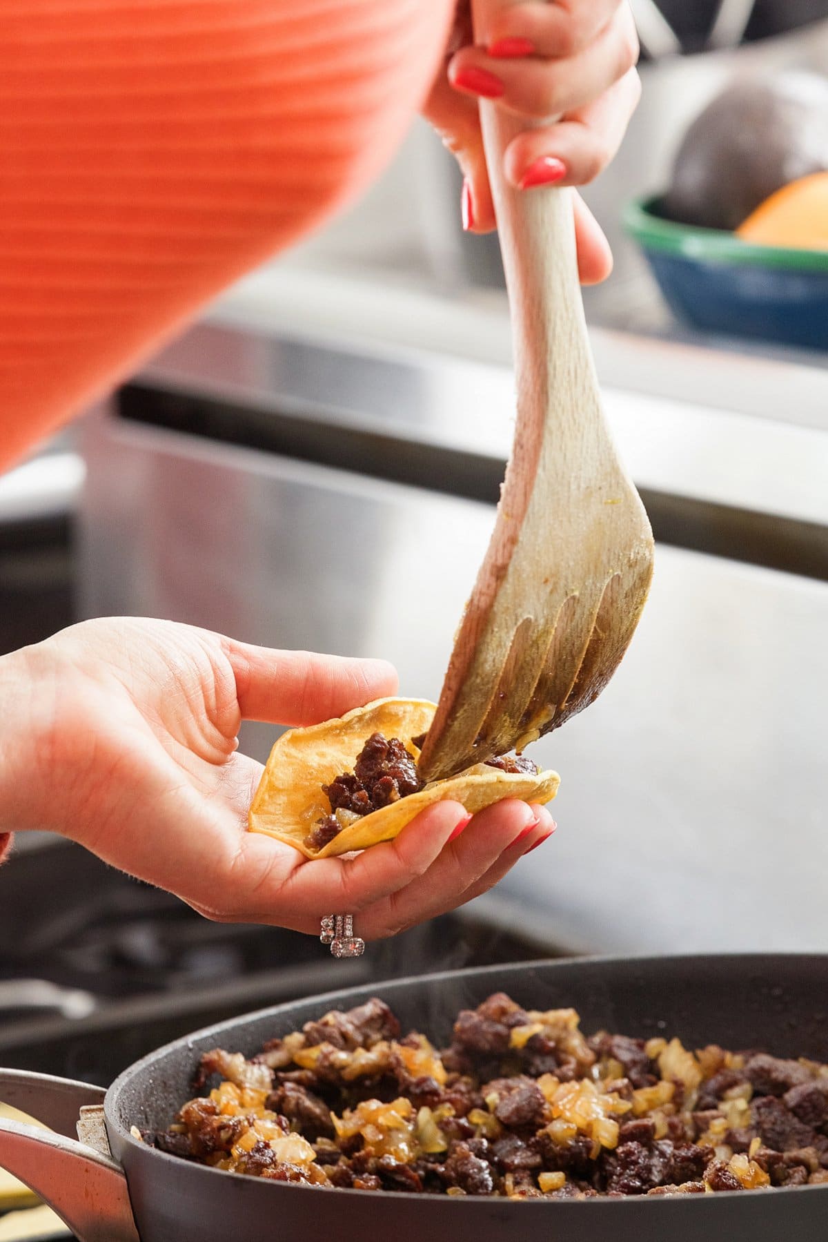 filling taco shells with beef