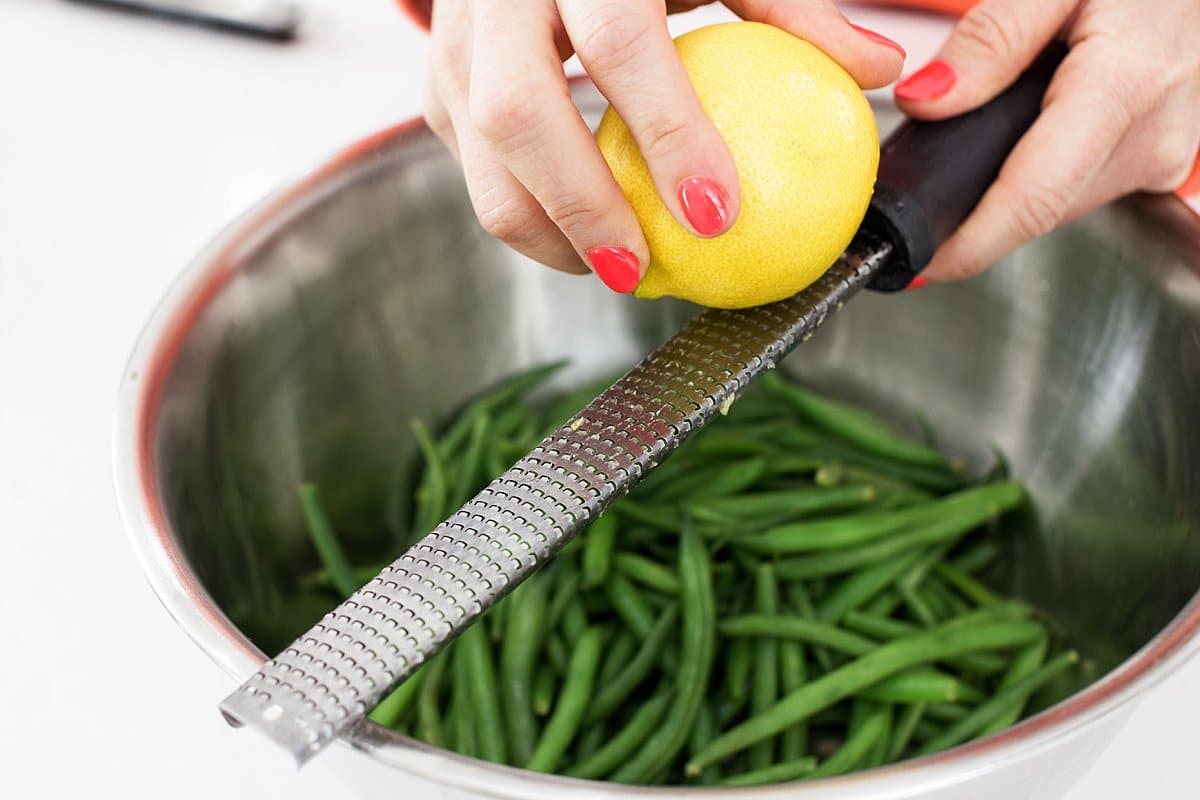 zesting lemon over green beans
