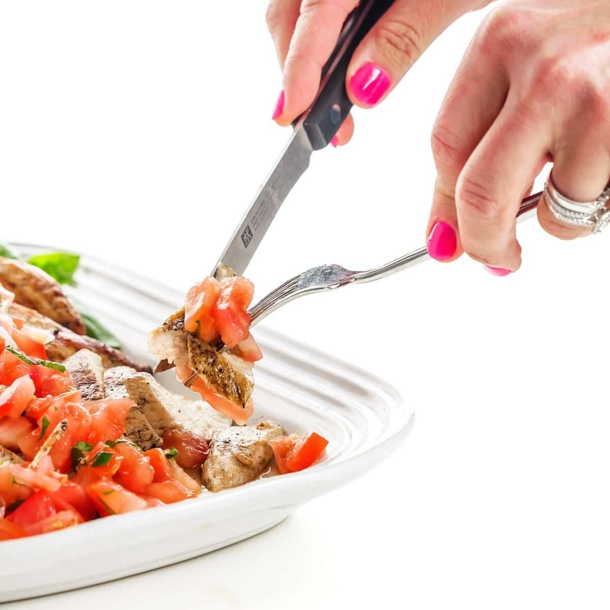 Grilled Chicken on a plate being cut up