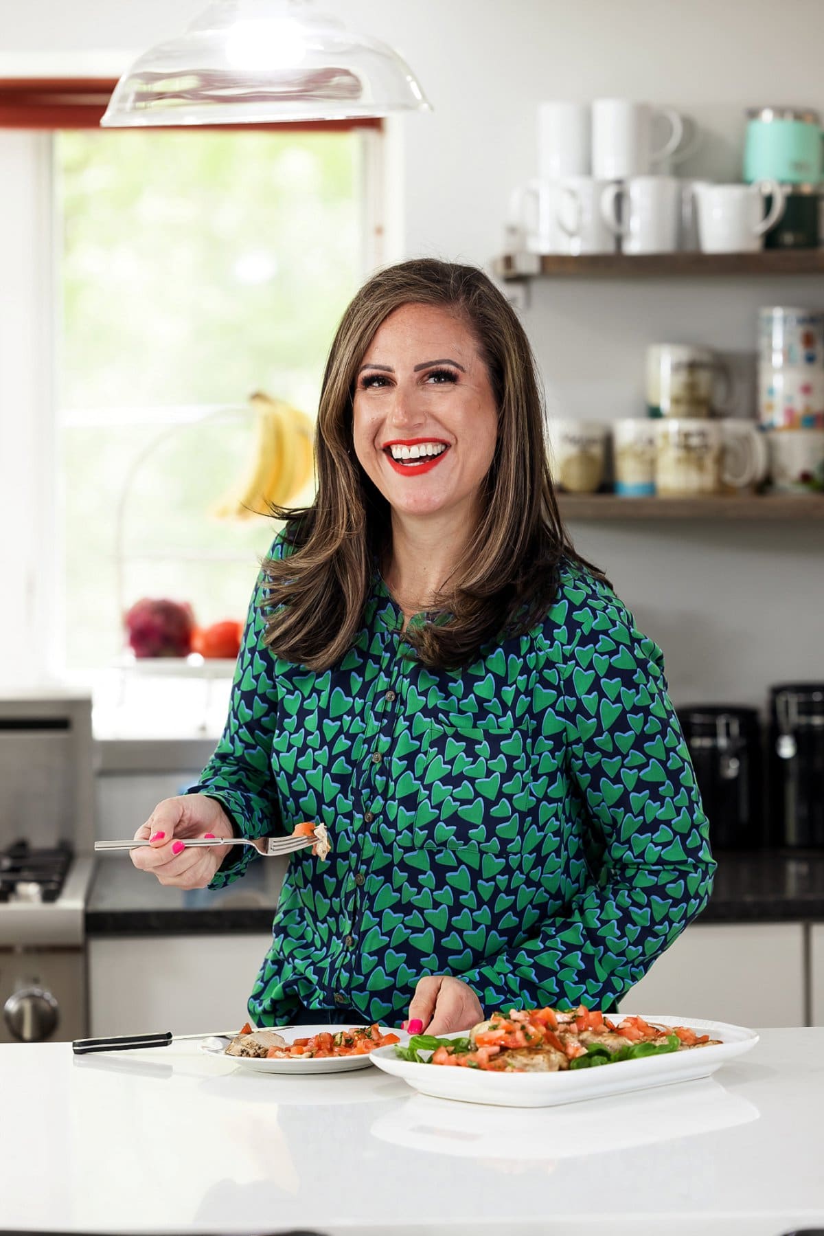 Liz eating grilled chicken with fresh tomato basil salsa.