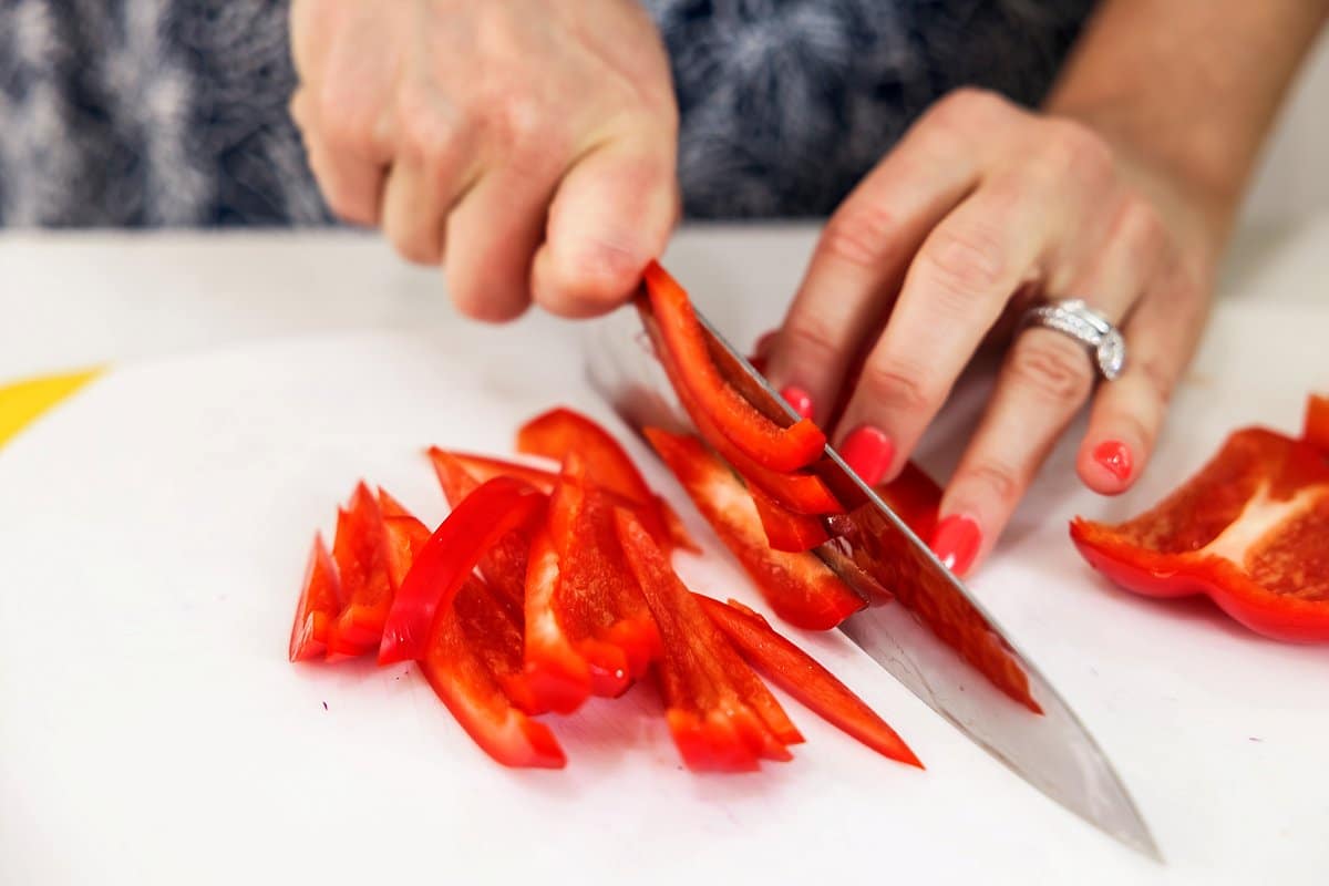 chopping red peppers