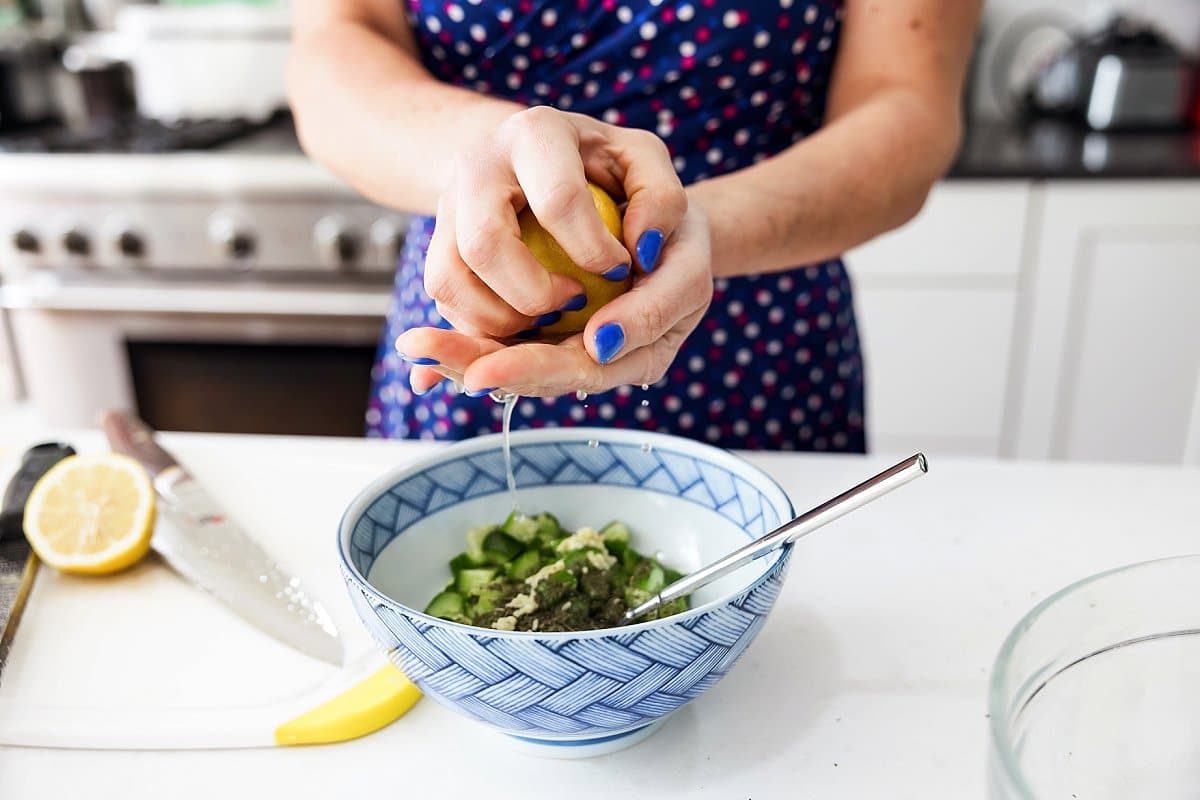 Adding lemon to a bowl