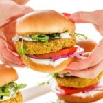 person holding Vegetarian chickpea burgers with tzatziki sauce