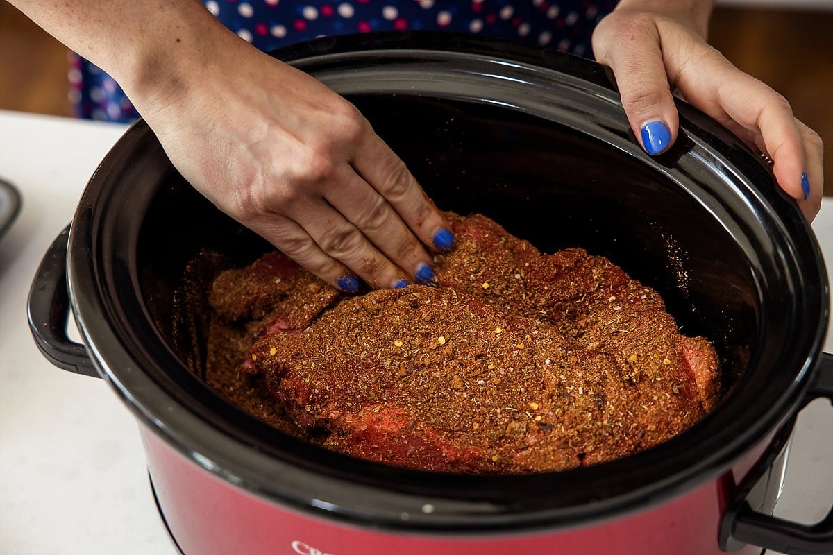 spreading rub on beef