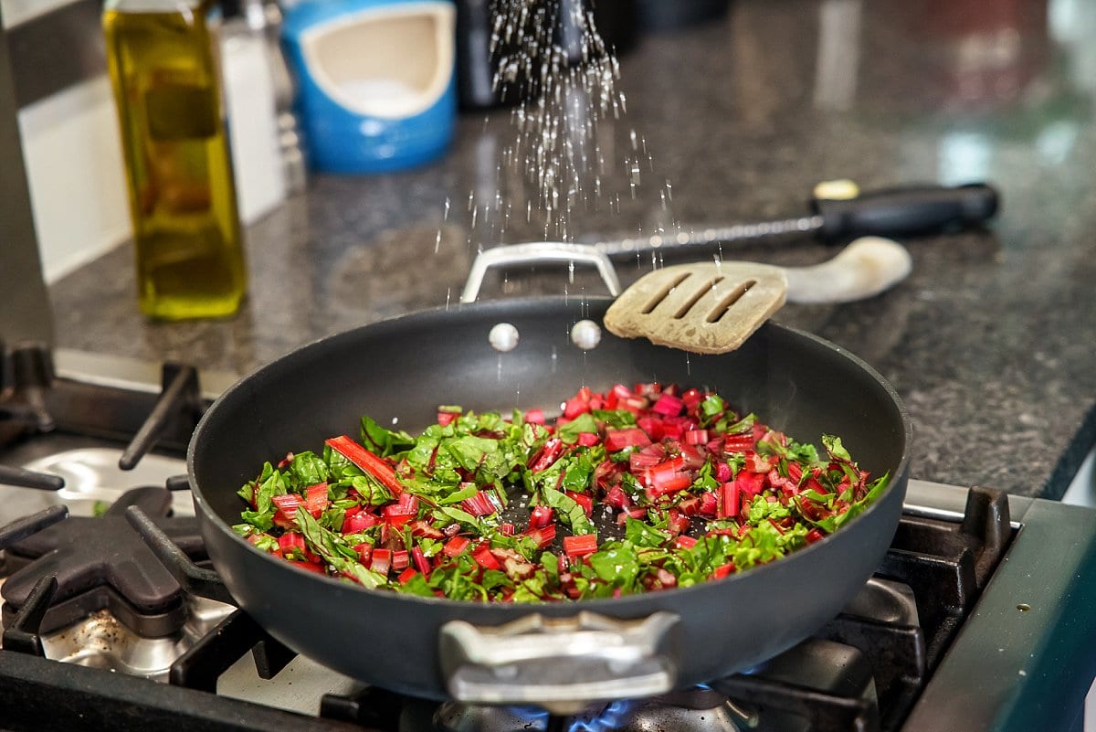 Adding salt to saute pan