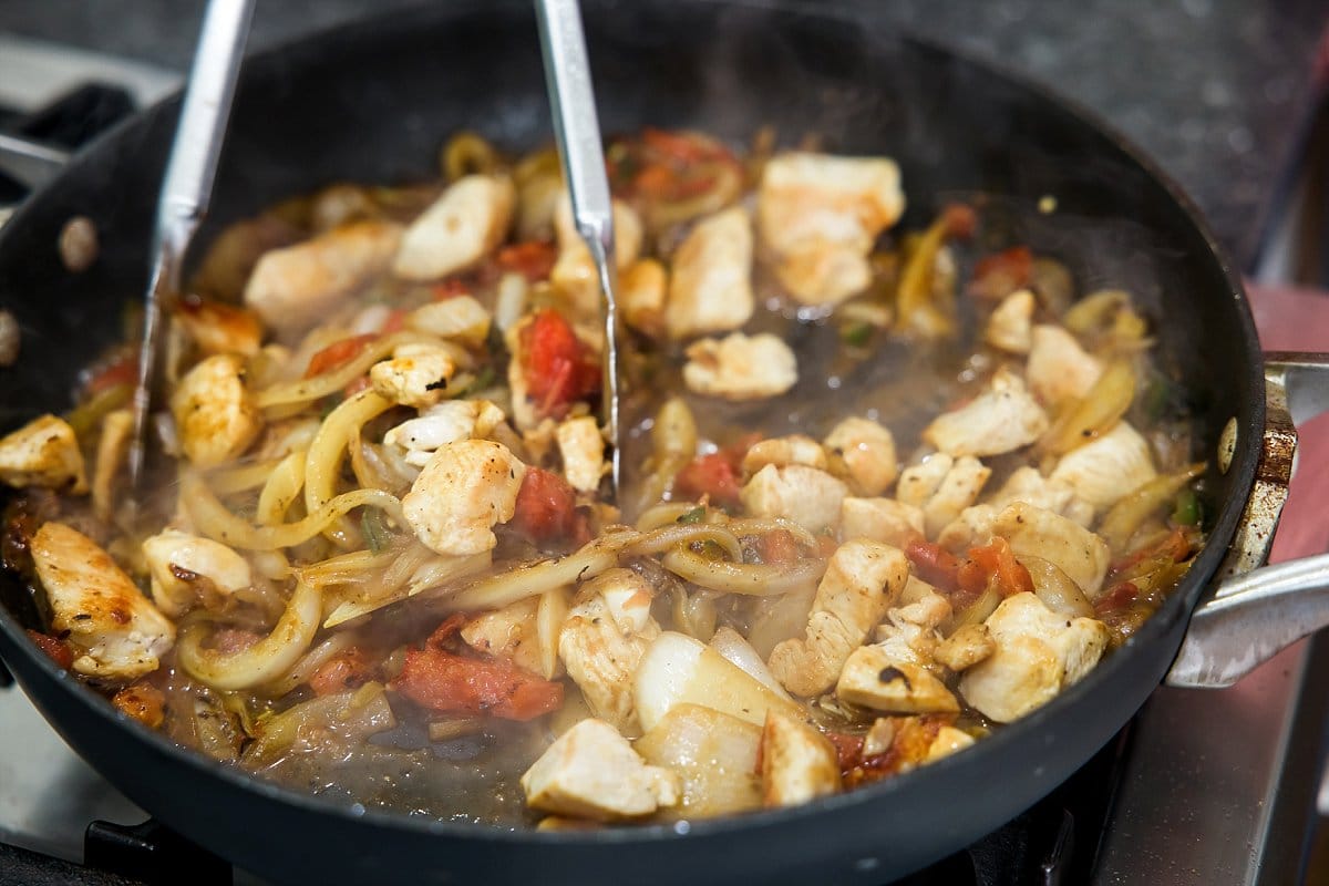 Cooking spicy chicken sauté with jalapeño.