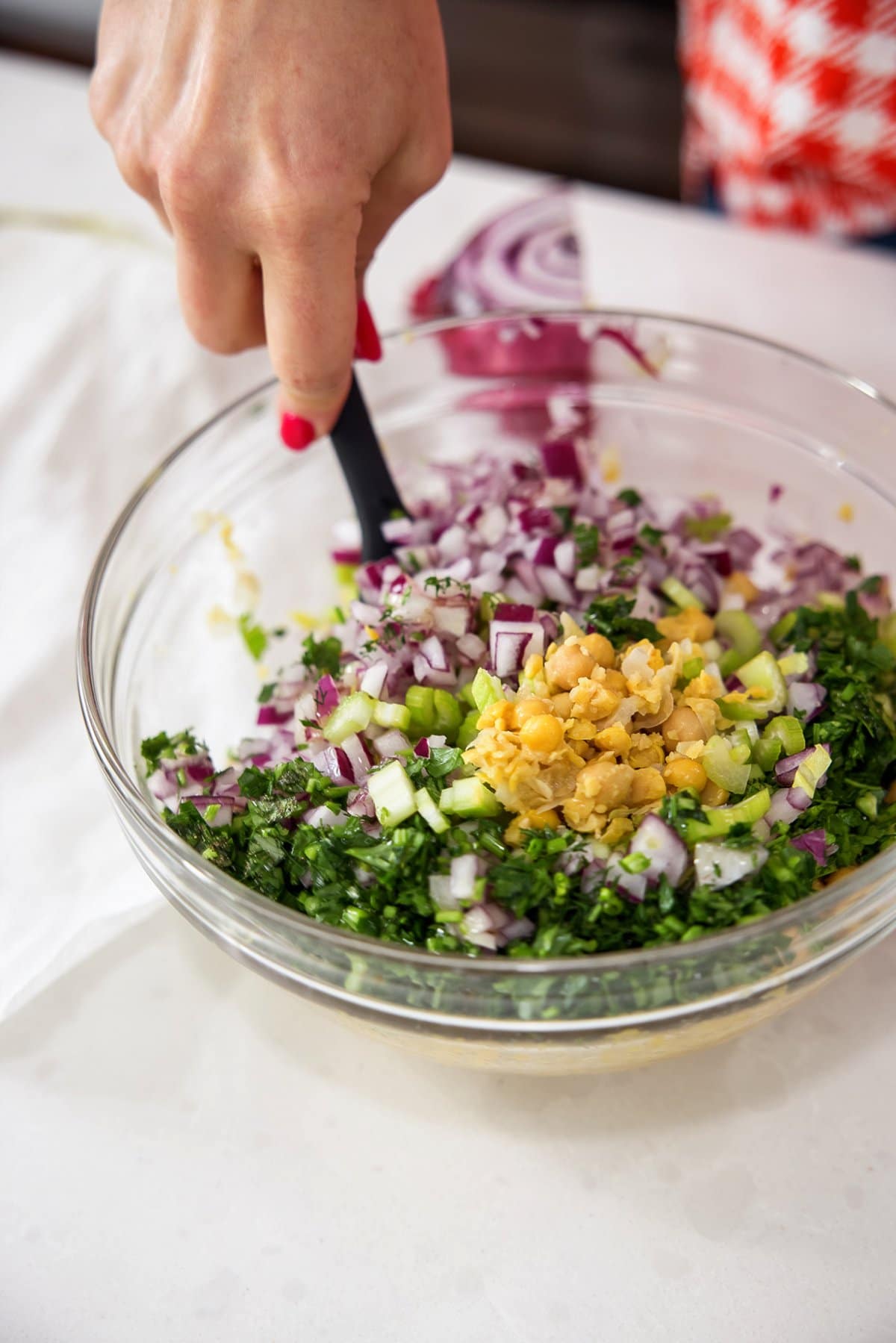 Liz tossing smashed chickpea salad with dill.