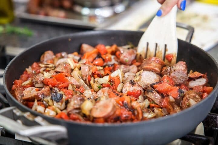 stirring pasta in a pan