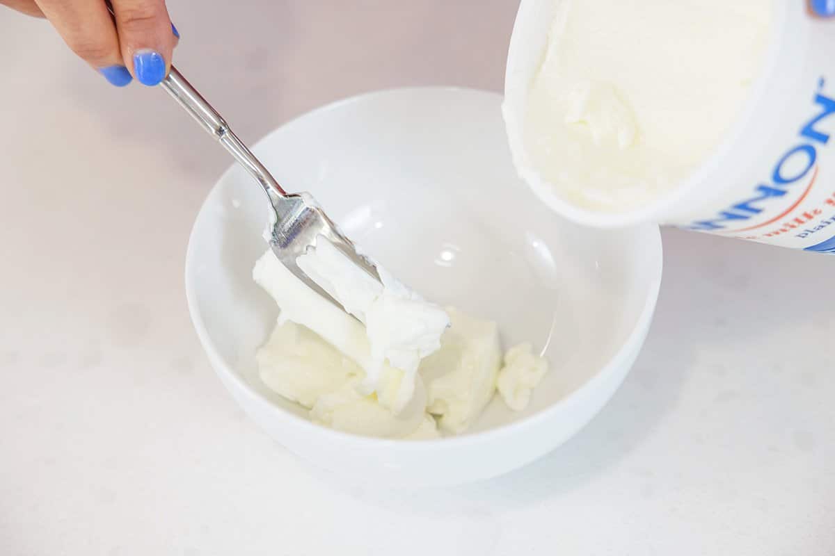 Adding yogurt to empty bowl