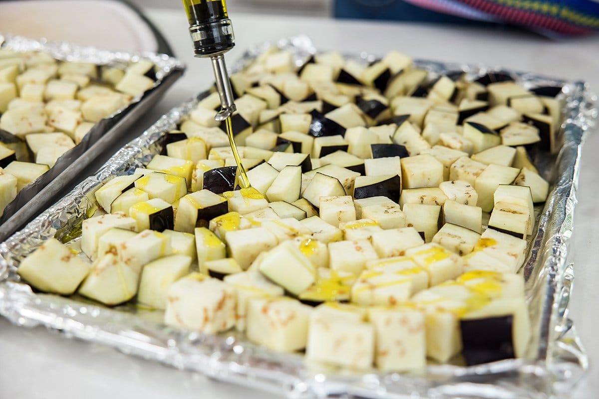 Drizzling oil onto eggplant