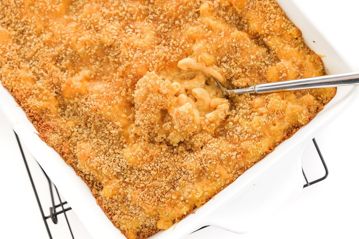 Serving healthy baked mac and cheese with pumpkin.
