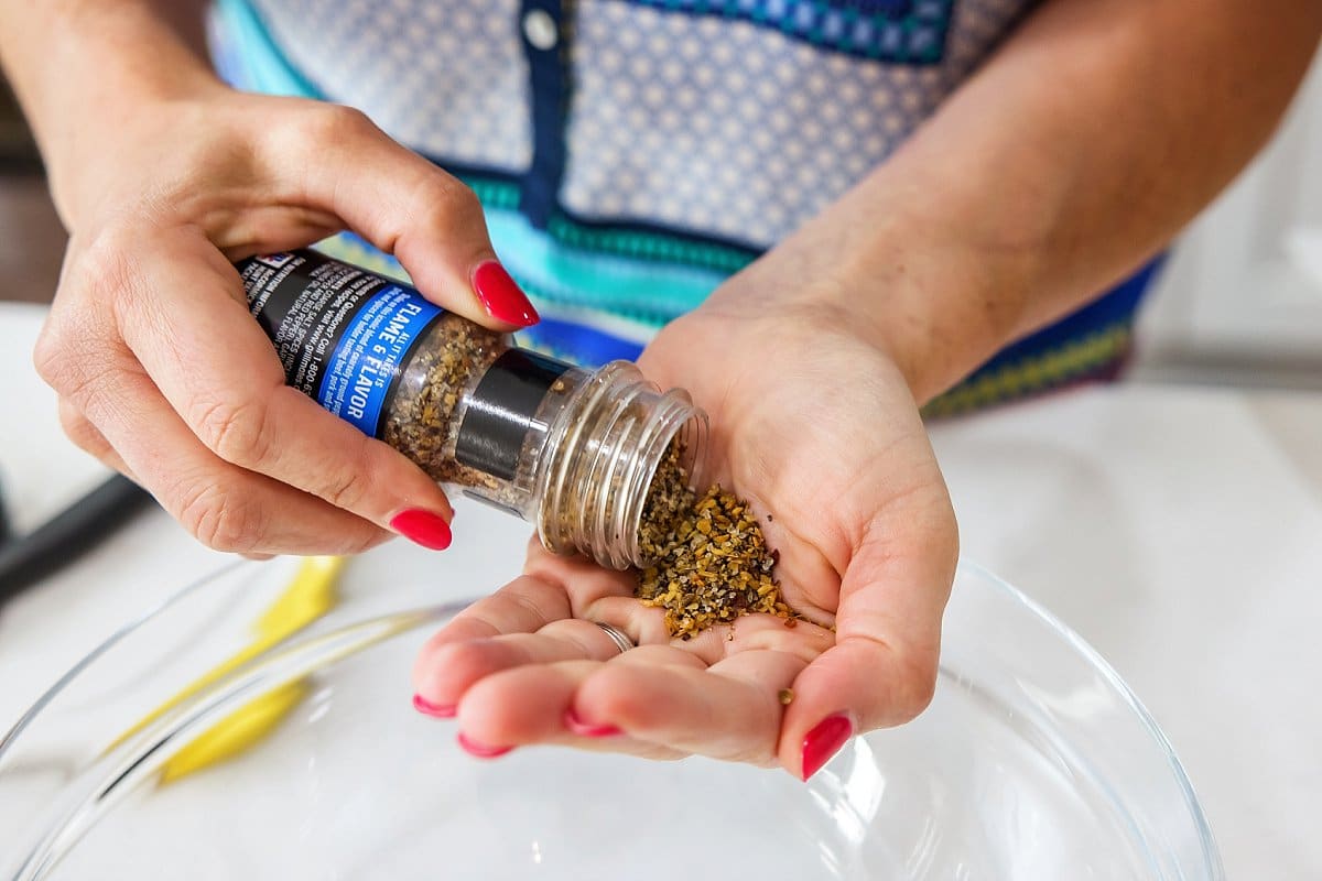 person portioning grill seasoning