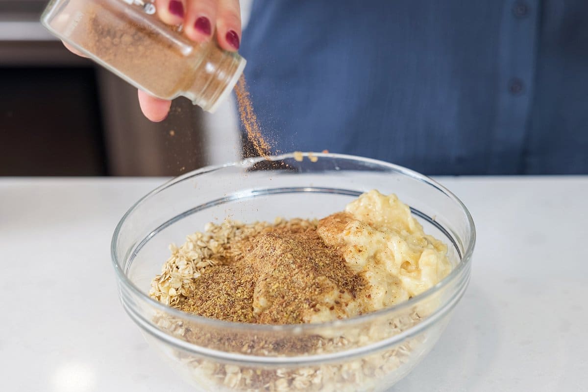 Adding cinnamon to batter in a bowl