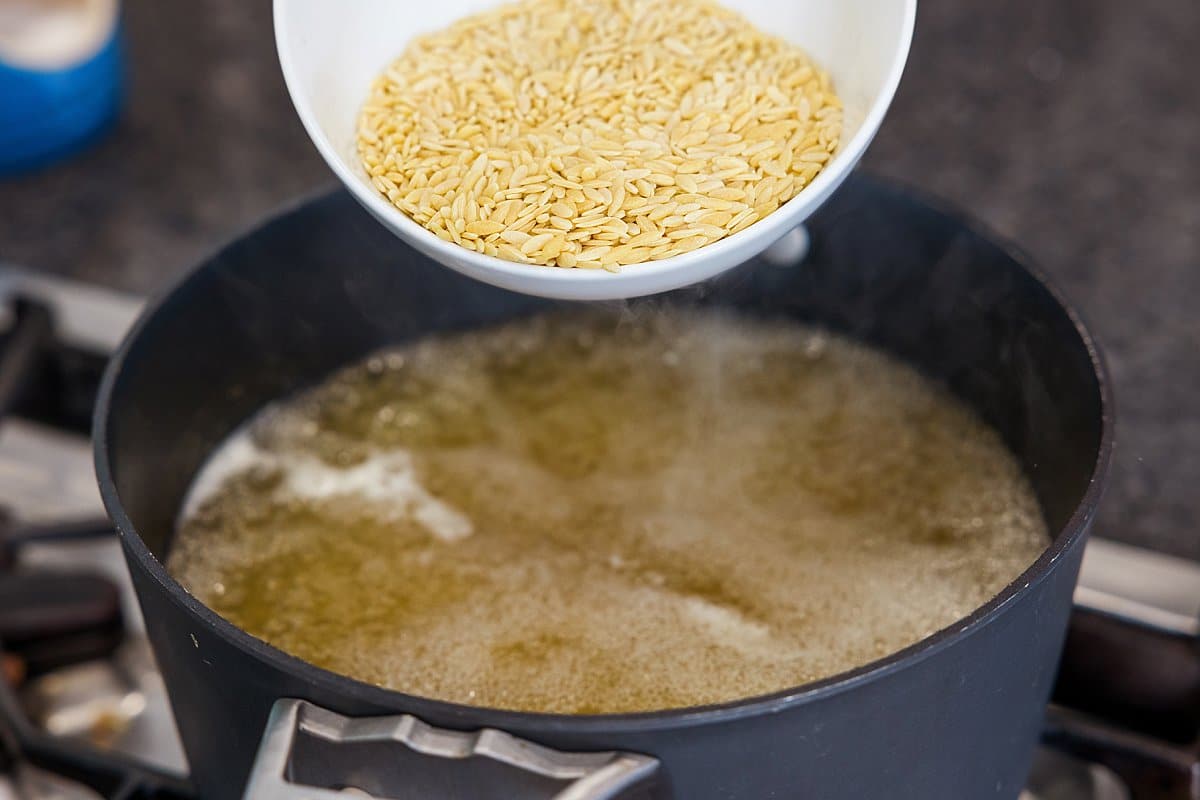 Adding orzo to boiling chicken broth