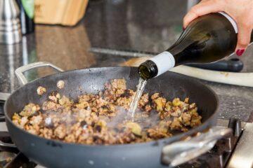 Adding wine to pan