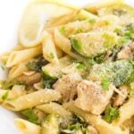 A close up of a plate of food with broccoli, with Chicken and Penne