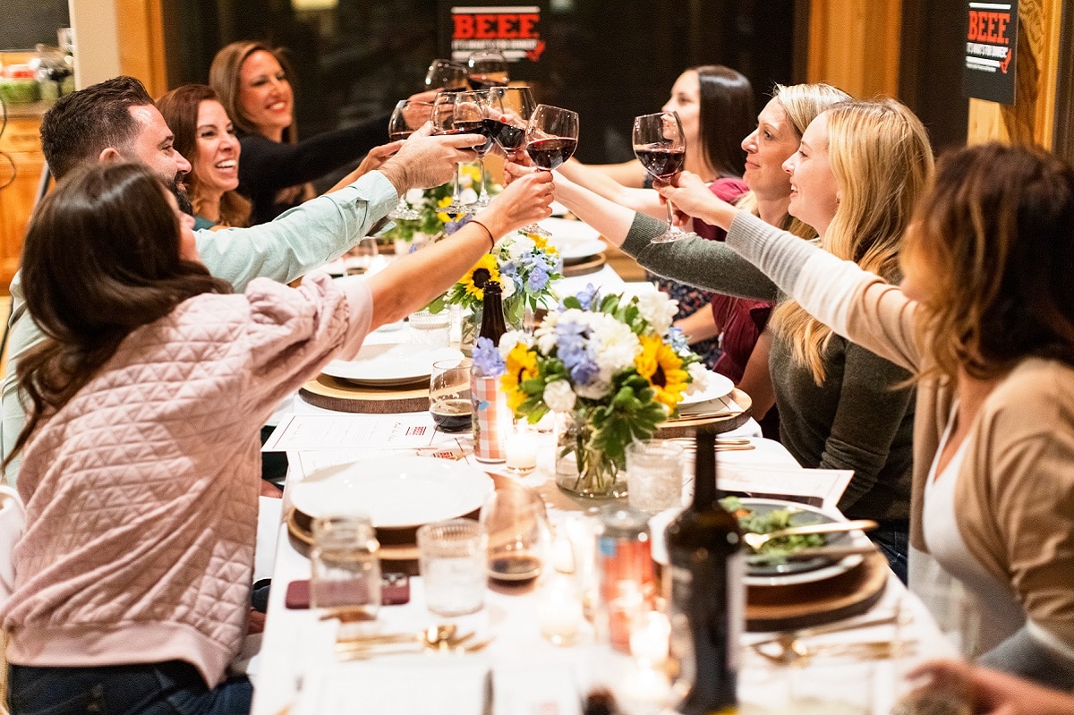 A group of people sitting at a table with wine glasses
