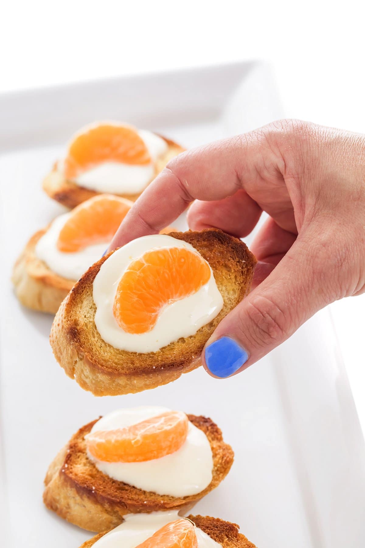 Hand holding crostini.