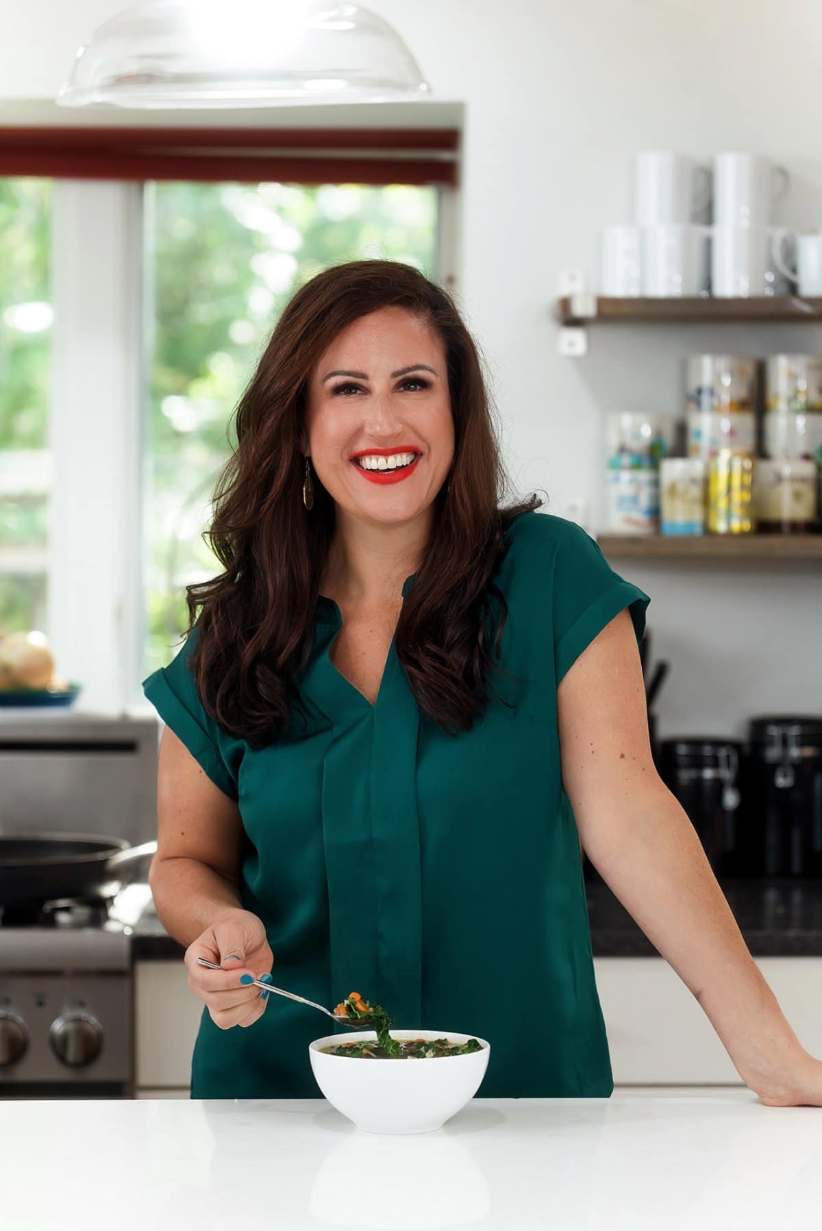 Liz eating creamy vegan mushroom rice soup.