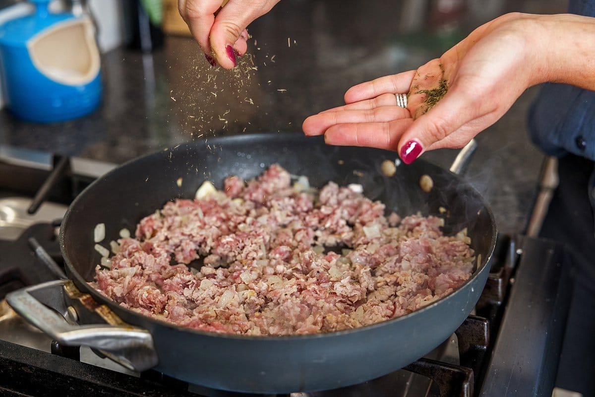 adding spices to a pan