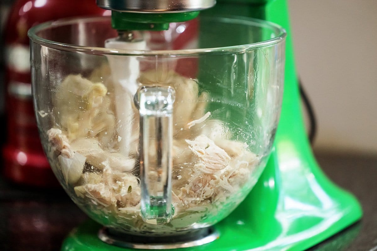 Shredding chicken in a stand mixer with the paddle attachment.