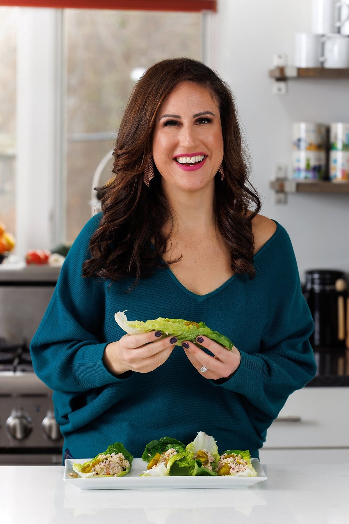 Liz eating healthy tuna salad lettuce cups.