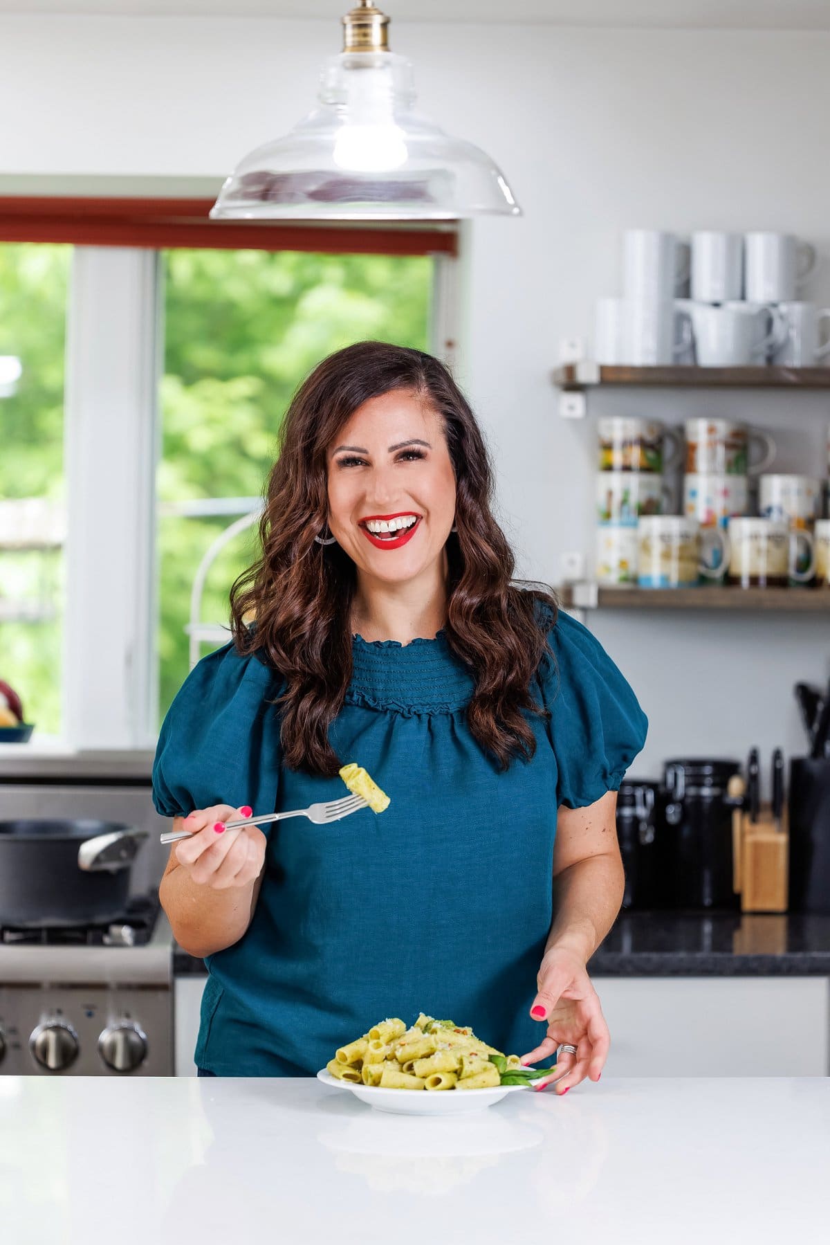 Liz eating fresh basil pesto.