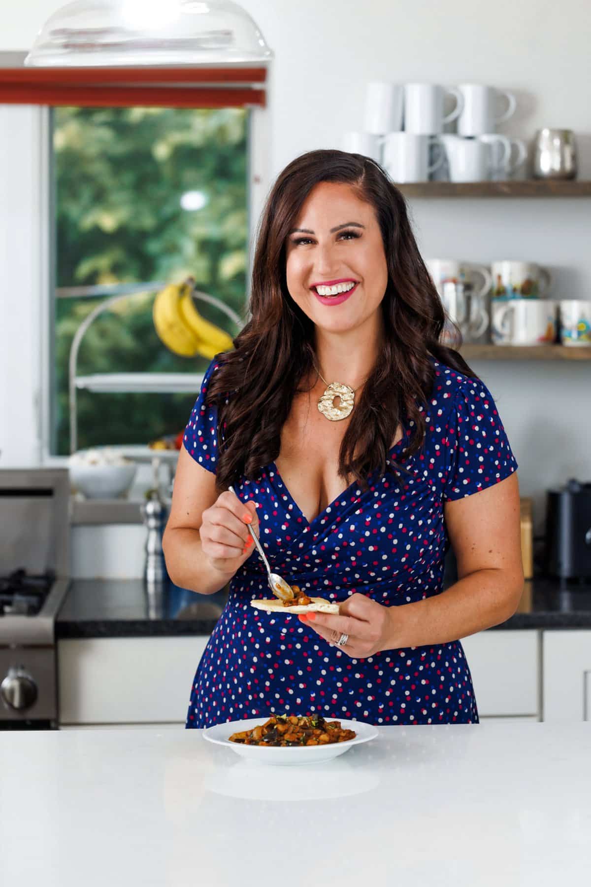Liz eating eggplant and chickpea stew.