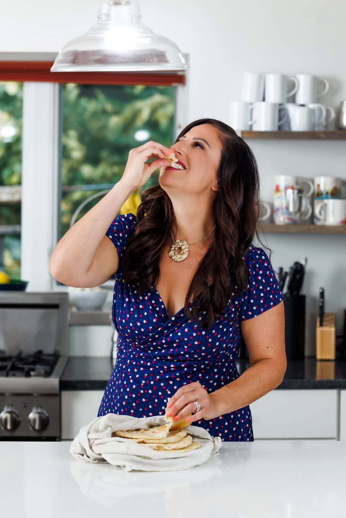 Liz eating restaurant style pita bread.