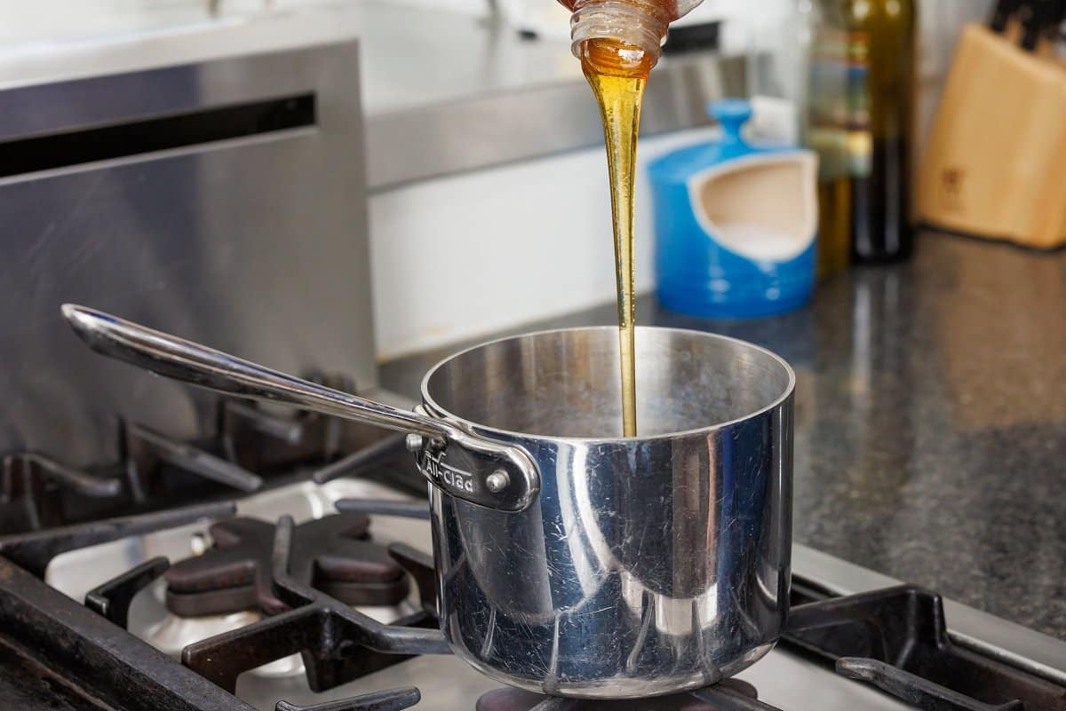 Adding honey to sauce pan.