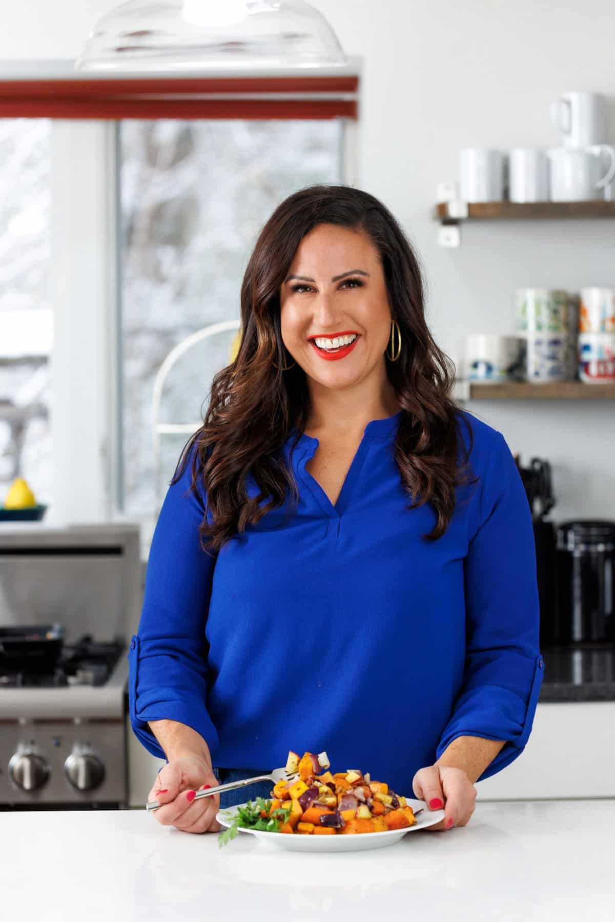 Liz eating herb-roasted apples, onions, and carrots.