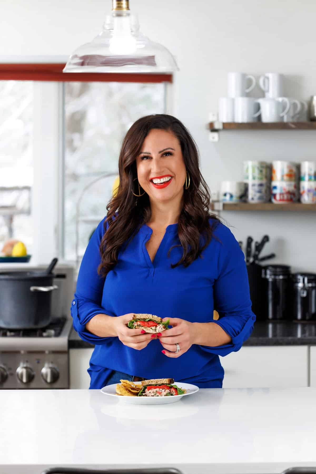 Liz eating mediterranean tuna salad sandwich.