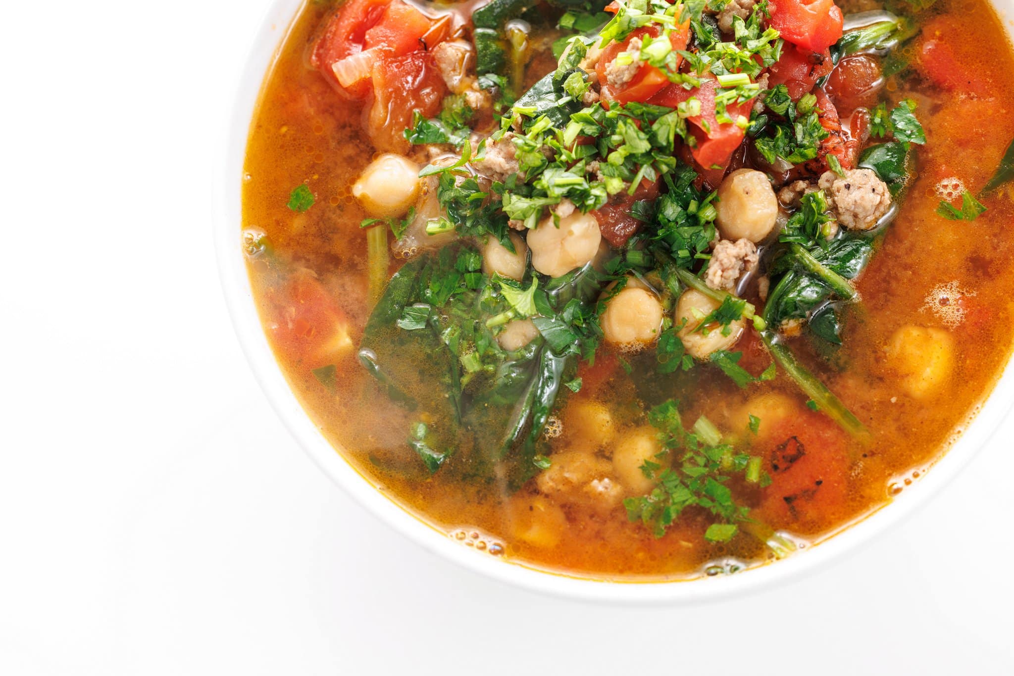 Lamb & chickpea stew with spinach topped with freshly minced parsley.