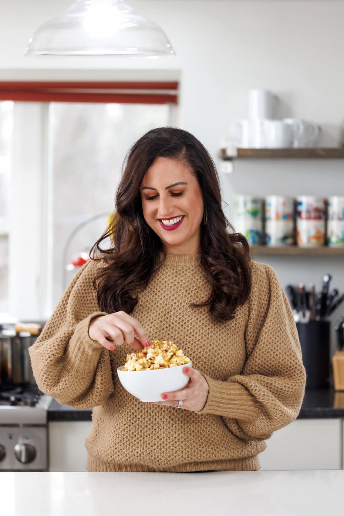 Liz eating peanut butter drizzled popcorn.