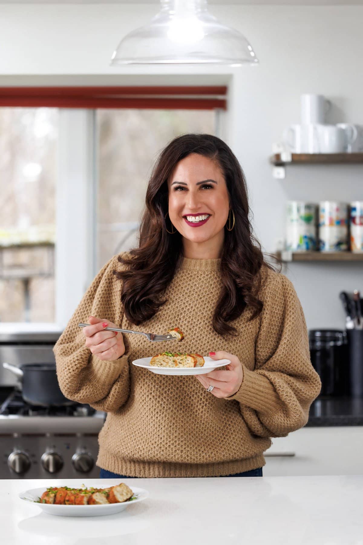 Liz eating turkey meatloaf with rosemary.