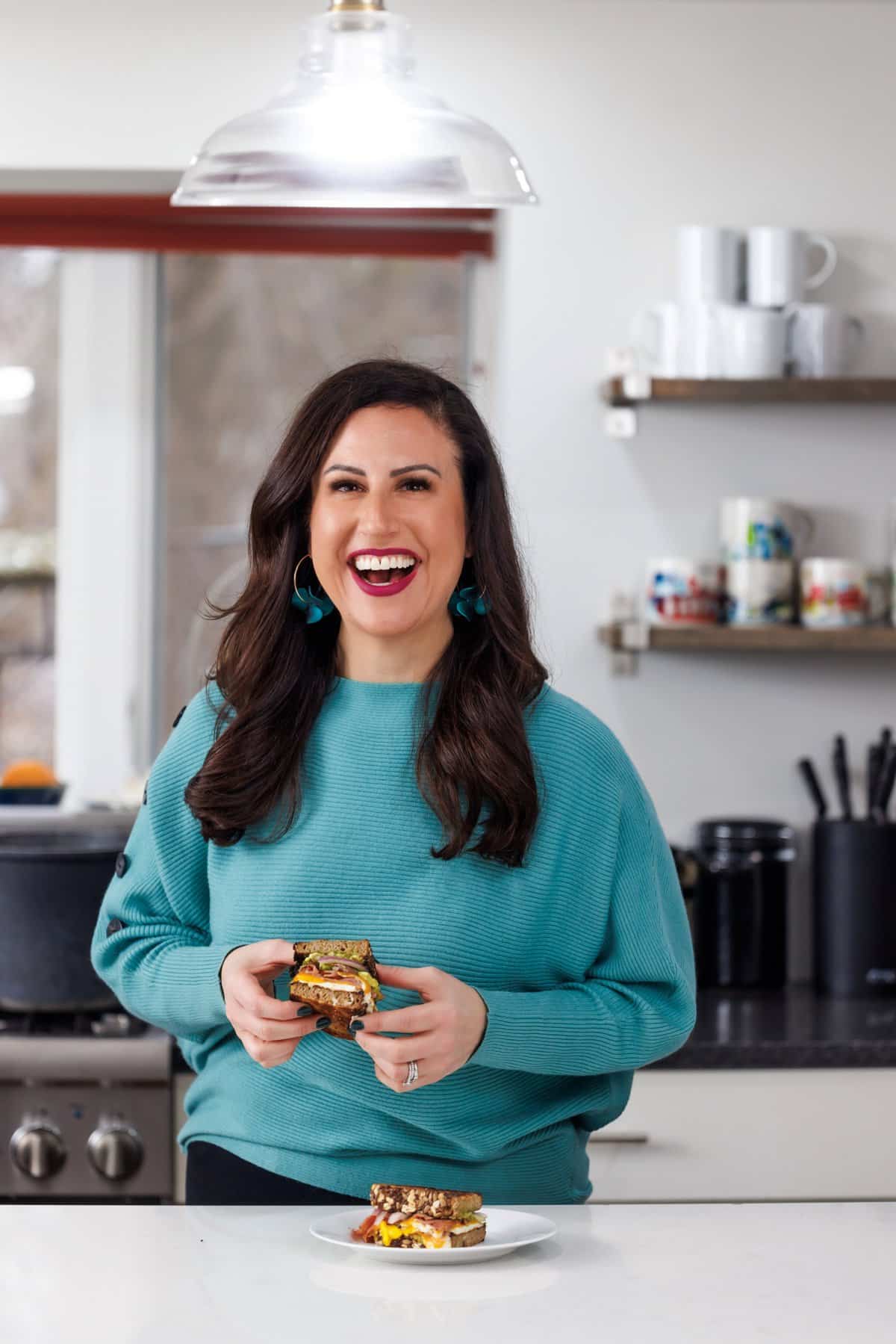 Liz eating an avocado egg sandwich.