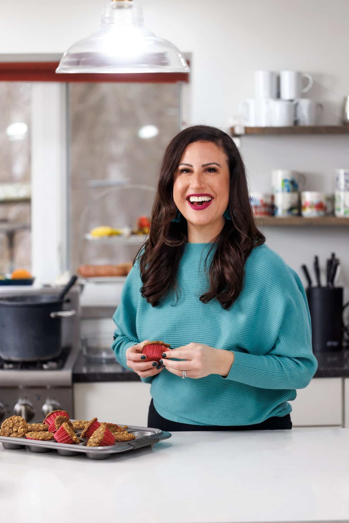 Liz eating a zucchini carrot muffin.