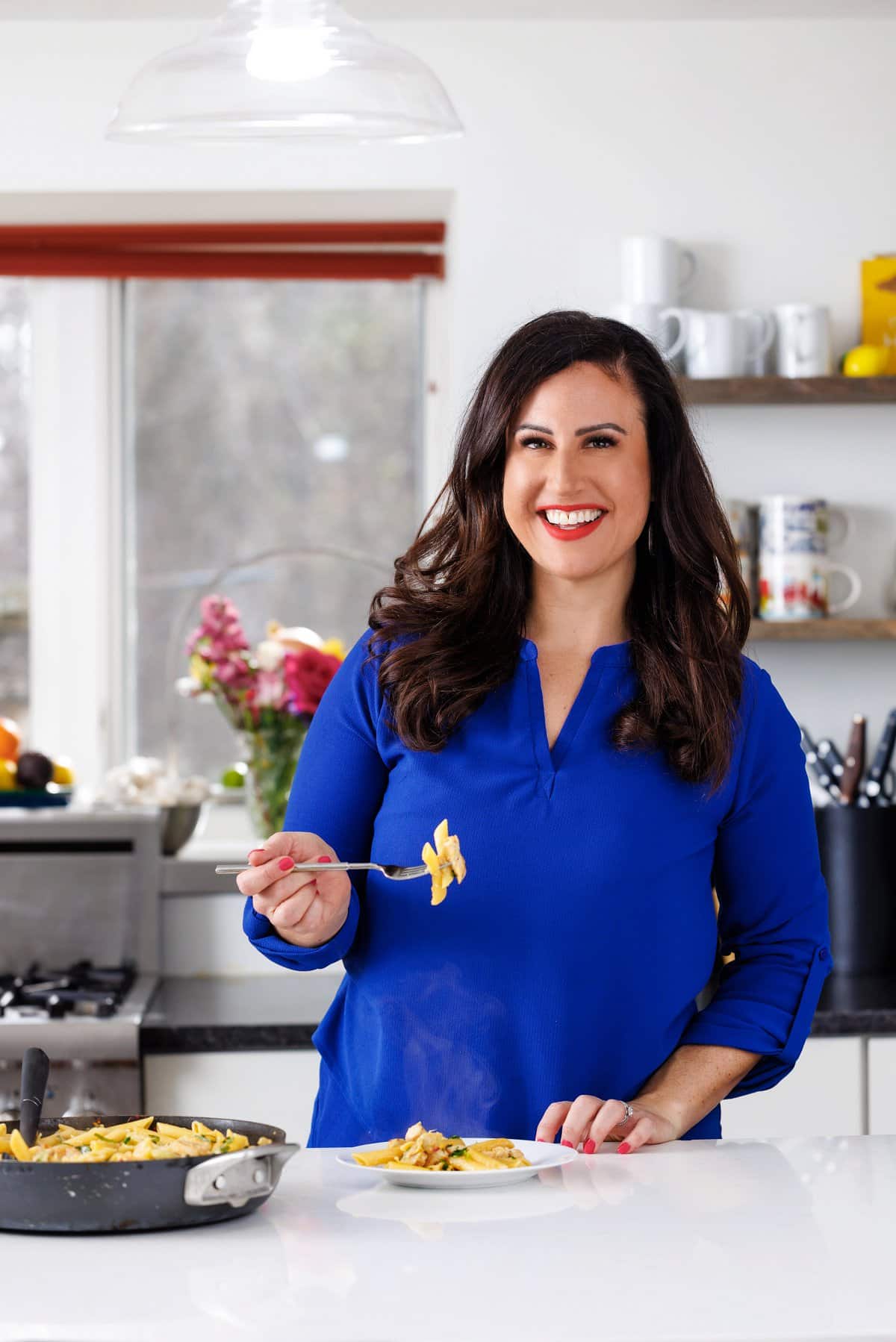 Liz enjoying Italian chicken pasta with artichokes.