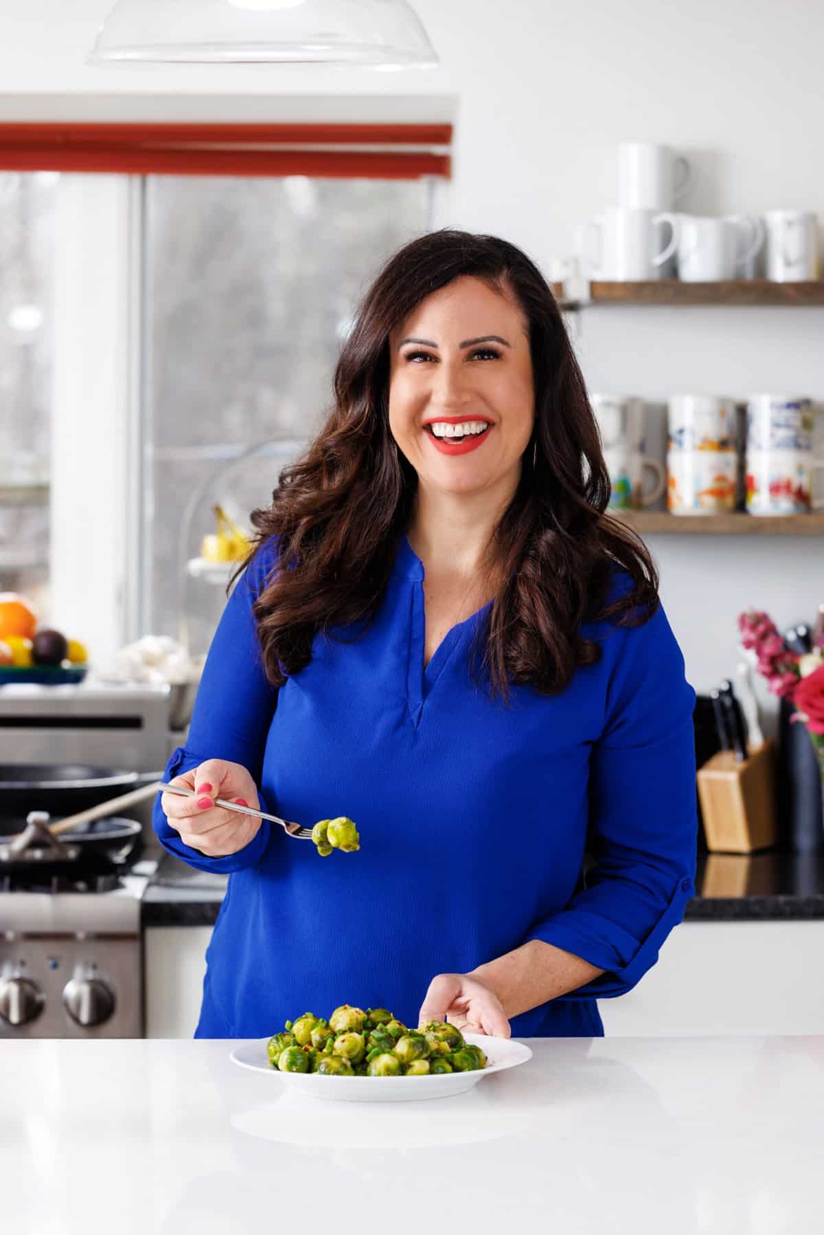 Liz eating steamed lemon garlic brussels sprouts.