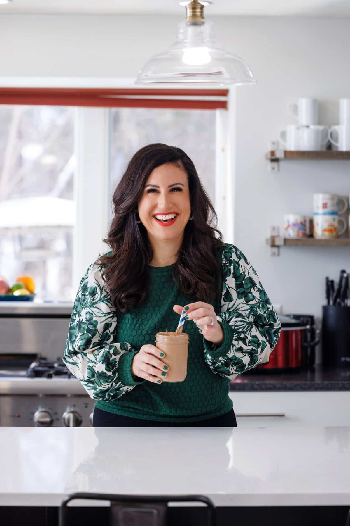 Liz drinking chocolate almond butter smoothie.