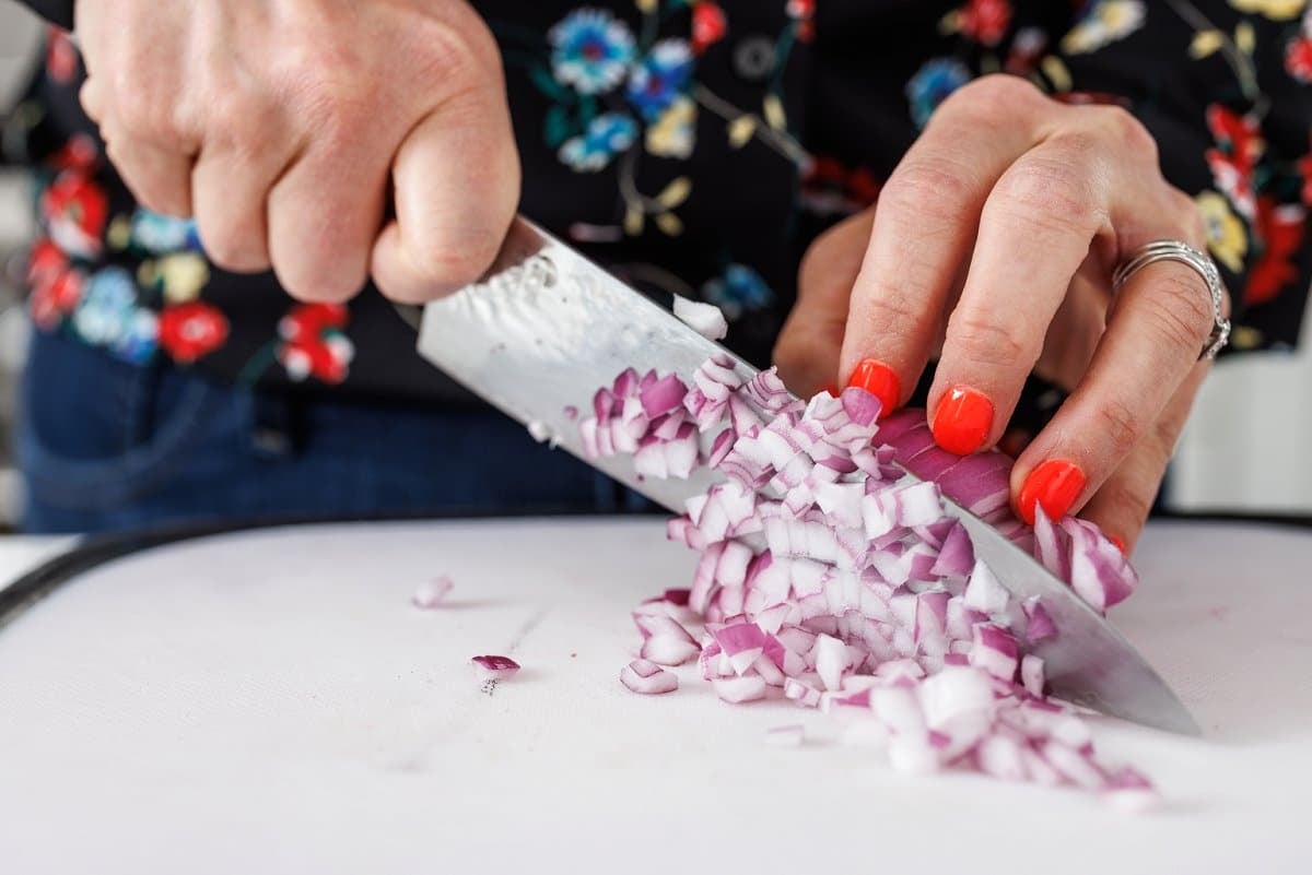 Liz dicing a red onion.