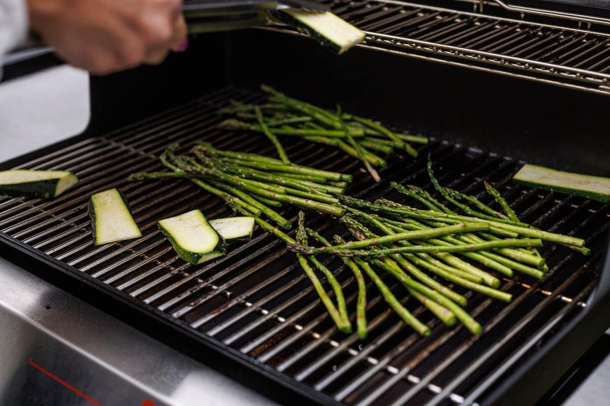 Asparagus and zucchini cooking on the grill.