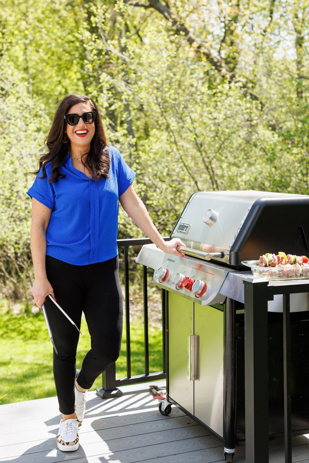 Liz grilling za'atar spiced grilled chicken outside on her grill.