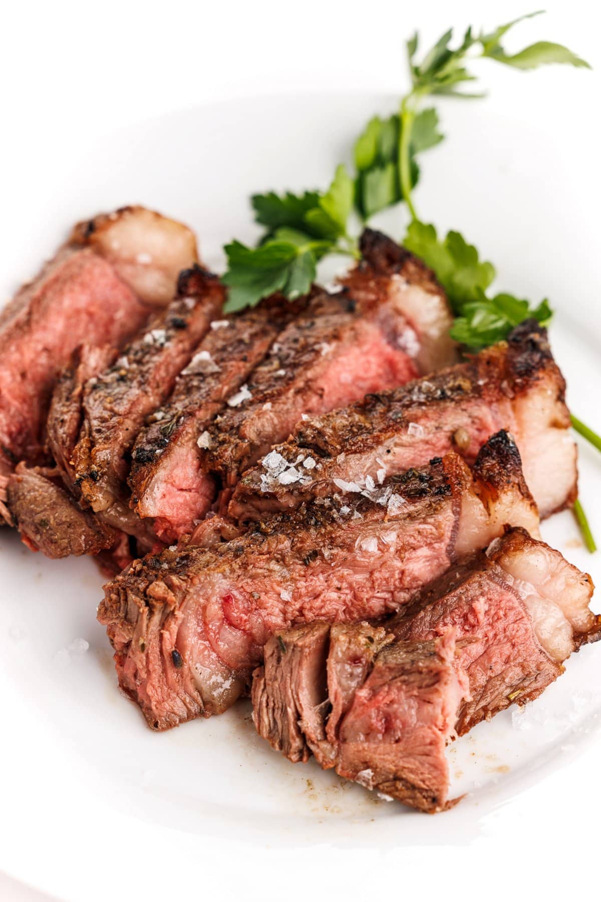 Sliced herbes de provence grilled porterhouse steak.